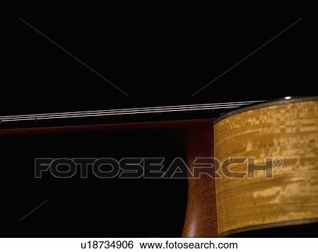 Close-up of an acoustic guitar View Large Photo Image Stock Photograph - Close-up of an acoustic guitar. Fotosearch