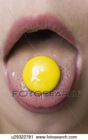 Close-up of mouth with candy on tongue View Large Photo Image Stock Image - Close-up of mouth with candy on tongue. Fotosearch