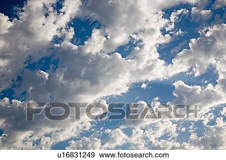 Stock Photo - Clouds in a blue sky. Fotosearch
