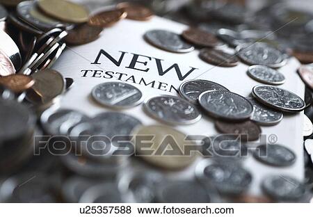 Coins covering the New Testament Bible View Large Photo Image Stock Photo - Coins covering the New Testament Bible. Fotosearch
