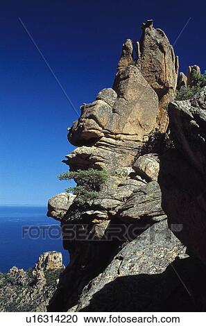 Stock Image - Corsica, France; Rock formation on a mountain above the sea. Fotosearch