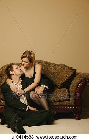 Couple embrace while sitting View Large Photo Image Stock Photo - Couple embrace while sitting. Fotosearch