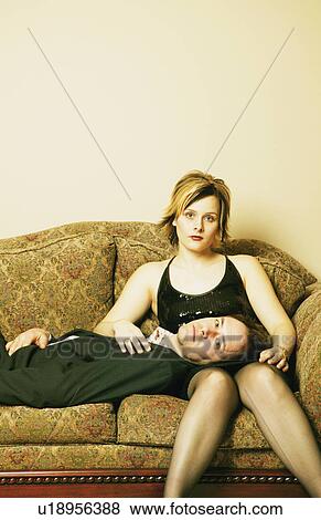 Couple hang out on the sofa View Large Photo Image Stock Photo - Couple hang out on the sofa. Fotosearch