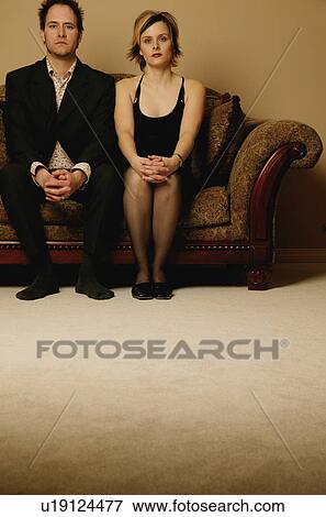 Couple sitting side by side View Large Photo Image Stock Photo - Couple sitting side by side. Fotosearch