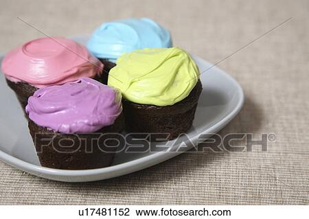 Cupcakes with colored icing View Large Photo Image Stock Image - Cupcakes with colored icing. Fotosearch