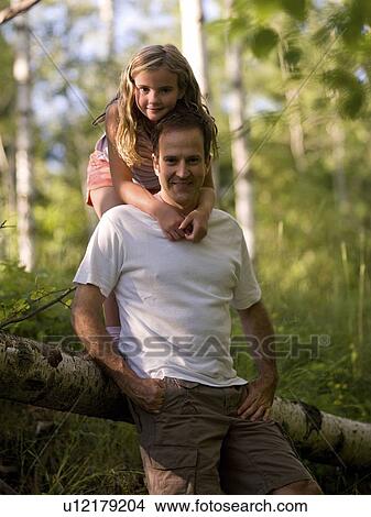 Daughter embracing father, Lake of the Woods, Ontario, Canada View Large Photo Image Picture - Daughter embracing father, Lake of the Woods, Ontario, Canada. Fotosearch