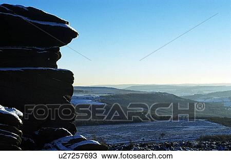 Stock Image - Derbyshire, England, United Kingdom; Snow covered rock formations in a national park. . Fotosearch