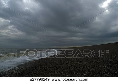 East Anglia, England, United Kingdom; Sea water rolling up a gravel beach View Large Photo Image Stock Photo - East Anglia, England, United Kingdom; Sea water rolling up a gravel beach. Fotosearch