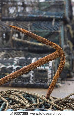 East Riding, Yorkshire, England; Rusty anchor and lobster pots on the seafront View Large Photo Image Stock Photo - East Riding, Yorkshire, England; Rusty anchor and lobster pots on the seafront. Fotosearch