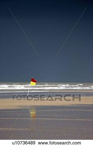 East Riding, Yorkshire, England; Surf warning flag in the wind View Large Photo Image Stock Photo - East Riding, Yorkshire, England; Surf warning flag in the wind. Fotosearch