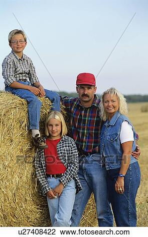 Stock Image - Family on their farm, Alberta, Canada. Fotosearch