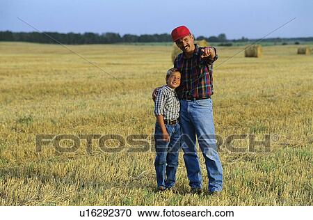 Farmer and son in field, Alberta, Canada View Large Photo Image Stock Image - Farmer and son in field, Alberta, Canada. Fotosearch