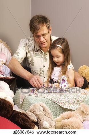 Stock Photography - Father and daughter having tea party. Fotosearch