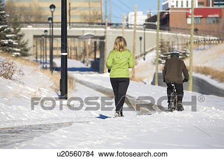 Female jogging, male bicycling View Large Photo Image Picture - Female jogging, male bicycling. Fotosearch