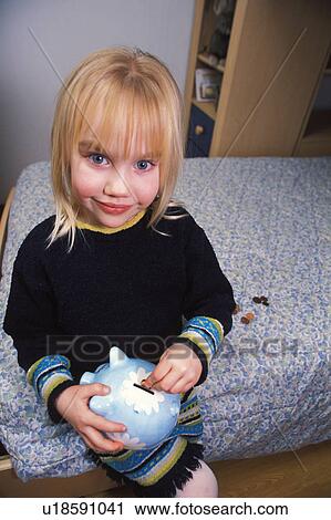 Stock Image - Filling piggy bank. Fotosearch