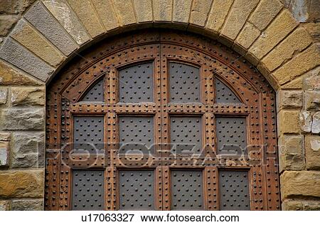 Stock Photo - Florence, Italy; Metal and wood door. Fotosearch