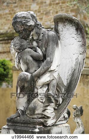Stock Photograph - Florence, Italy; Statue of angel holding baby. Fotosearch