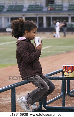 Girl at a baseball game View Large Photo Image Stock Photo - Girl at a baseball game. Fotosearch