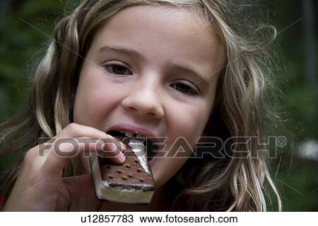 Girl eating ice cream bar, Lake of the Woods, Ontario, Canada View Large Photo Image Stock Image - Girl eating ice cream bar, Lake of the Woods, Ontario, Canada. Fotosearch