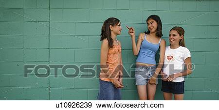 Stock Photo - Girls making fun. Fotosearch