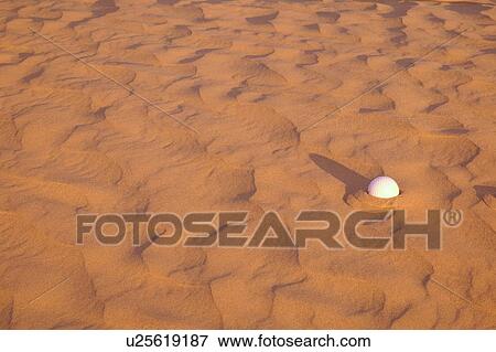 Golf ball lost in a sand trap View Large Photo Image Stock Photo - Golf ball lost in a sand trap. Fotosearch