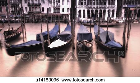 Stock Photograph - Gondolas in the Grand Canal at sunset Venice Italy. Fotosearch