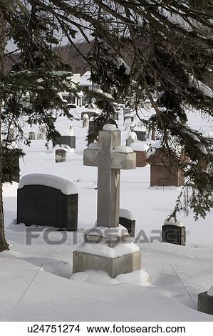 Gravestones in a cemetery covered in snow View Large Photo Image Picture - Gravestones in a cemetery covered in snow. Fotosearch