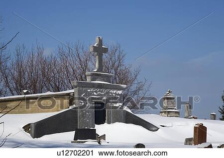 Gravestones in a cemetery covered in snow View Large Photo Image Stock Image - Gravestones in a cemetery covered in snow. Fotosearch