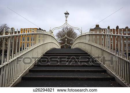 Stock Image - Ha'penny Bridge, Dublin, Ireland; Detail of Ha'penny Bridge across the river Liffey. Fotosearch