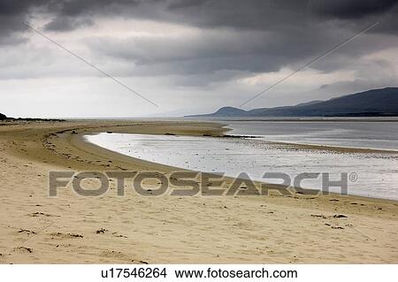 Picture - Islay, Scotland; Storm clouds by a beach. Fotosearch