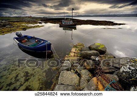 Islay, Scotland; Two boats anchored by a beach View Large Photo Image Picture - Islay, Scotland; Two boats anchored by a beach. Fotosearch