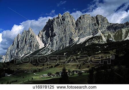 Stock Photography - Italy; Rock formations towering over houses. Fotosearch