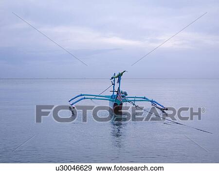 Stock Photo - Java sea, Bali, Indonesia; Jukung a Balinese fishing vessel. Fotosearch