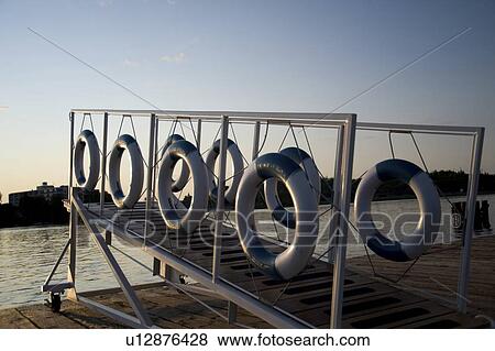 Kenora, Lake of the Woods, Ontario, Canada; Life preservers hanging on a dockside gangway View Large Photo Image Stock Photo - Kenora, Lake of the Woods, Ontario, Canada; Life preservers hanging on a dockside gangway. Fotosearch