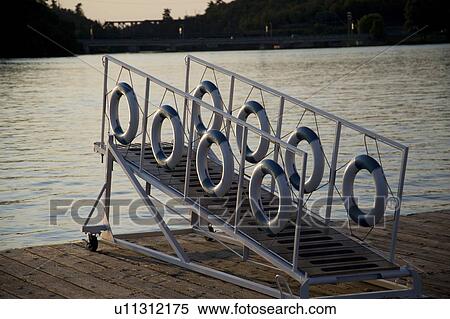 Kenora, Lake of the Woods, Ontario, Canada; Life preservers hanging on a dockside gangway View Large Photo Image Stock Photography - Kenora, Lake of the Woods, Ontario, Canada; Life preservers hanging on a dockside gangway. Fotosearch