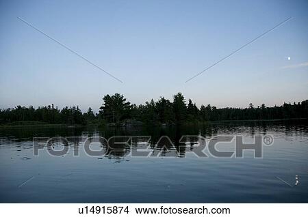 Lake of the Woods, Ontario, Canada; Sunset over placid lake View Large Photo Image Picture - Lake of the Woods, Ontario, Canada; Sunset over placid lake. Fotosearch