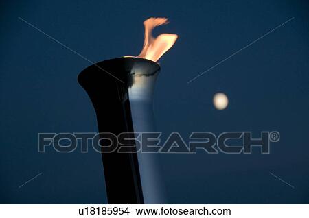 Picture - Lake of the Woods, Ontario, Canada; Torch burning brightly at night. Fotosearch