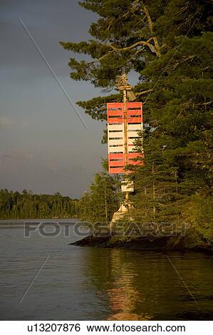 Stock Photograph - Lake of the Woods, Ontario, Canada; Red and white nautical sign on lake. Fotosearch