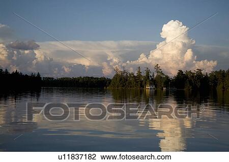 Stock Image - Lake of the Woods, Ontario, Canada; View of woods next to a lake. Fotosearch