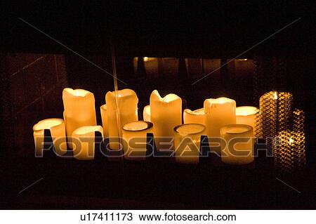 Stock Image - Lake of the Woods, Ontario, Canada; Candles burning brightly in dark room. Fotosearch