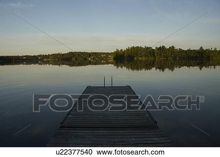 Stock Image - Lake of the Woods, Ontario, Canada; Pier looking out over lake toward forest. Fotosearch