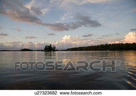 Stock Image - Lake of the Woods, Ontario, Canada; View of woods next to a lake. Fotosearch