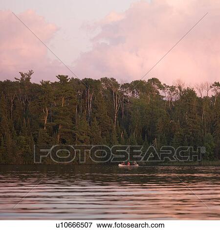 Lake of the Woods, Ontario, Canada; Tourists venture around Lake of the Woods at sunset View Large Photo Image Stock Photo - Lake of the Woods, Ontario, Canada; Tourists venture around Lake of the Woods at sunset. Fotosearch