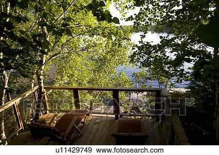 Stock Photo - Lake of the Woods, Ontario, Canada; Dock and Lake Building overlooking the lake. Fotosearch