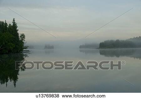 Lake of the Woods, Ontario, Canada; View across lake at sunrise View Large Photo Image Stock Photo - Lake of the Woods, Ontario, Canada; View across lake at sunrise. Fotosearch