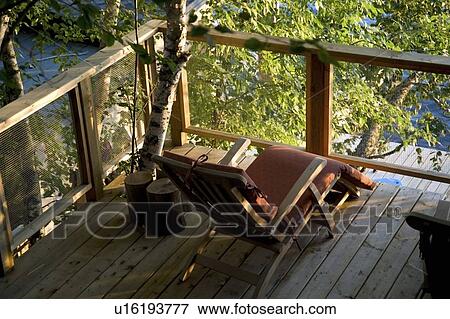 Lake of the Woods, Ontario, Canada; Chair on a deck View Large Photo Image Stock Photo - Lake of the Woods, Ontario, Canada; Chair on a deck. Fotosearch