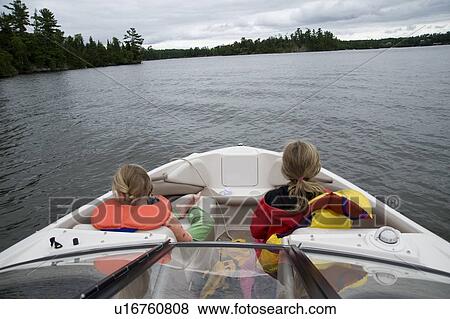 Lake of the Woods, Ontario, Canada; Girls sitting in front of boat View Large Photo Image Stock Photo - Lake of the Woods, Ontario, Canada; Girls sitting in front of boat. Fotosearch