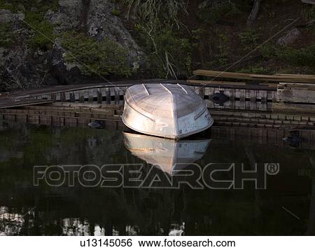 Stock Photograph - Lake of the Woods, Ontario, Canada; Boat on a dock . Fotosearch