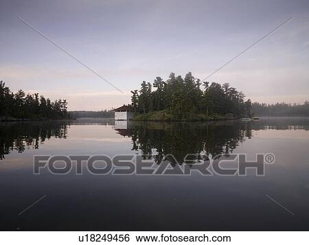 Stock Photograph - Lake of the Woods, Ontario, Canada; Boathouse on an island. Fotosearch
