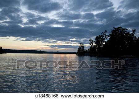 Lake of the Woods, Ontario, Canada; Sunset over placid lake View Large Photo Image Stock Photograph - Lake of the Woods, Ontario, Canada; Sunset over placid lake. Fotosearch